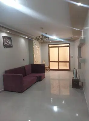 a living room with a couch and a television in it at شقه الحنان in Dayr as Si‘nah