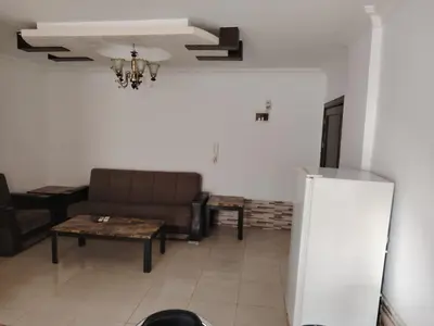 a living room with a couch and a table at Apartments for Rent in Irbid
