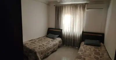 a hotel room with two beds and a window at الخليل 3 in Irbid