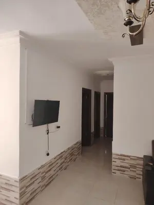 a room with white walls and a tv on the wall at الخليل 3 in Irbid