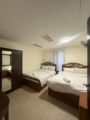 a bedroom with two beds and a mirror at arabian gulf in Al Burj