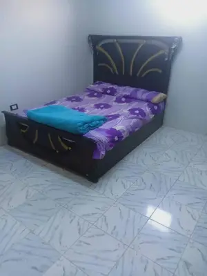 a bed in a room with a purple comforter at الريف فيلا in Ar Ramthā