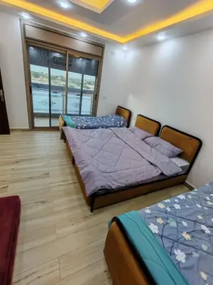 a bedroom with two beds and a window at Wonder Villa in Al Rama
