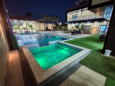 an image of a swimming pool at night at Wonder Villa in Al Rama