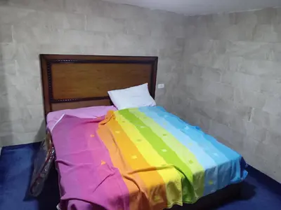 a bed with a colorful blanket on it in a room at Sky2 in Jerash
