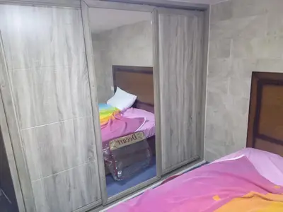 a mirror in a room with two beds at Sky2 in Jerash