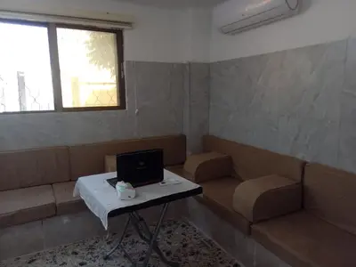 a living room with a couch and a table with a laptop at Sky2 in Jerash