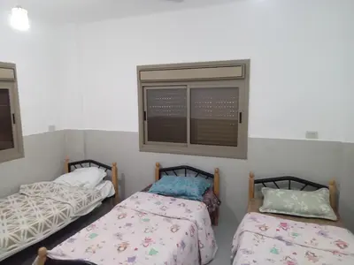 a room with two beds and a window at Sky 2 in Jerash