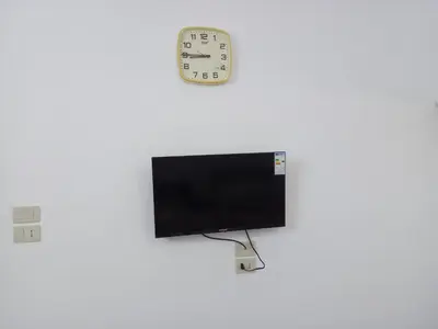 a computer monitor with a clock on the wall at Sky 2 in Jerash