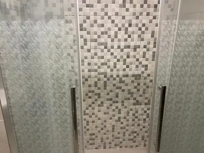 a shower with a glass door in a bathroom at Abdoun is comfortable accommodation and an exceptional location close to the mall in Amman