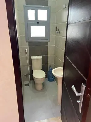 a bathroom with a toilet and a sink at ranos villa in An Nu‘ayyimah