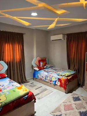 a bedroom with two beds and curtains in it at ranos villa in An Nu‘ayyimah