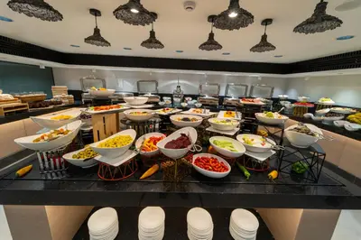a buffet with many bowls of food on a table at Hill Top Hotel in Aqaba