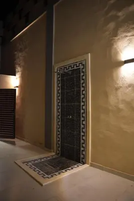 a room with a gate in the corner of a wall at Lumen villa in Umm Uthainah