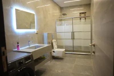 a bathroom with a sink and a toilet at Lumen villa in Umm Uthainah