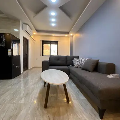a living room with a couch and a table at اربد in Irbid