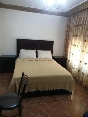 a bedroom with a bed and a chair in it at الاردن عمان تلاع العلي شارع ابو يوسف الأنصاري اسكان طارق الشيخ in Amman