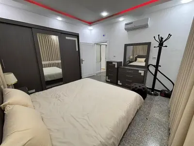 a bedroom with a large bed and a mirror at Raha's house in Jerash