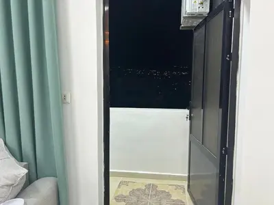 a door to a room with a view of a city at Raha's house in Jerash