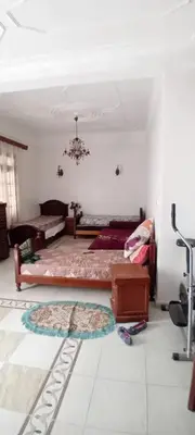 a living room with a bed and a rug at النعيمه هاوس in An Nu‘ayyimah