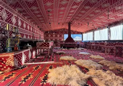 a large room with a large room with red walls and a red floor at Rum Sky Experiences in Wadi Rum