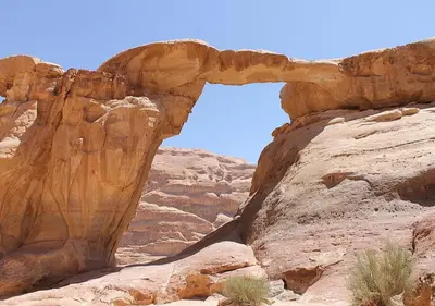 an arch in the rocks in the desert at Rum Sky Experiences in Wadi Rum