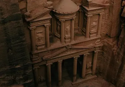 a stone building with a clock on the side of it at Rum Sky Experiences in Wadi Rum
