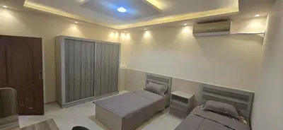 a room with a couch and a bed in it at الريان غرفتين نوم in Amman