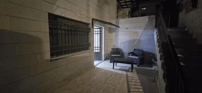 an empty hallway with two chairs in a building at الريان غرفتين نوم in Amman