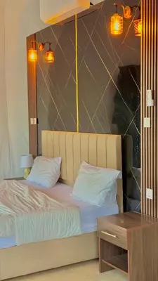 a bed with two pillows and a table in a room at Tarf Wadi Rum Luxury Camp & Jeep Tours in Wadi Rum