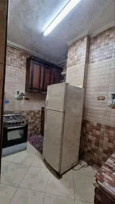 a kitchen with a refrigerator and a stove at ام الدنانير هاوس in Rujm al Ḩāwī