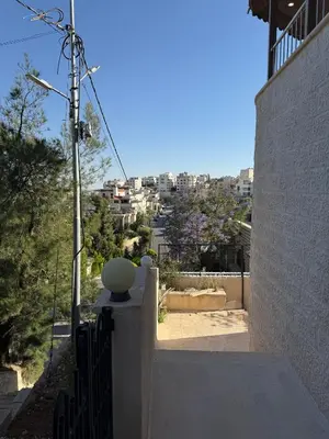 a balcony of a house with a view of a city at Warm 1BR in Dabouq in Amman