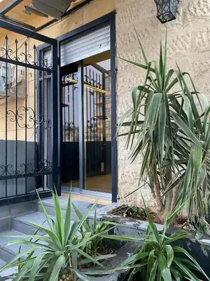 a front door of a building with plants at beautiful apartment in the DeadSea in Sowayma