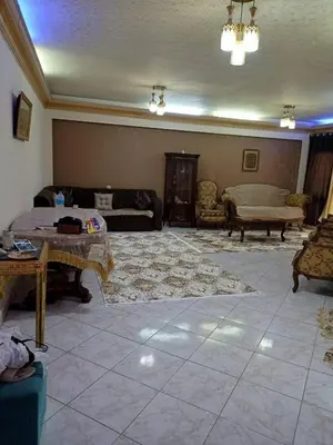 a large living room with a couch and a table at ام النعمان شليت in Umm as Surab