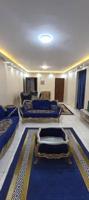 a room with three beds and a blue rug at ام النعمان شليت in Umm as Surab