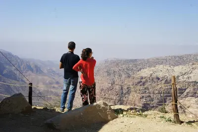 two people standing on top of a mountain view at Dana Village lodge and Camp-Wadi Dana Eco camp in Dana