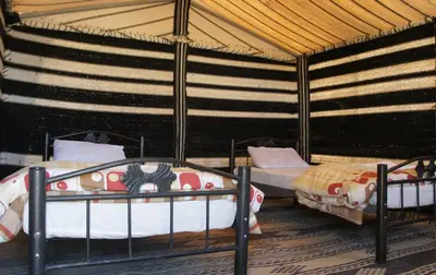 a room with two bunk beds in a tent at Dana Village lodge and Camp-Wadi Dana Eco camp in Dana
