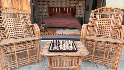 a room with a chessboard on a table and two chairs at Wadi Rum Camp and Tours in Wadi Rum
