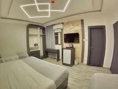 a bedroom with a bed and a television in a room at Holiday Season Hotel in Aqaba