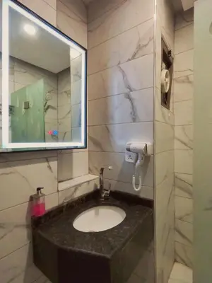 a bathroom with a sink and a mirror at Holiday Season Hotel in Aqaba
