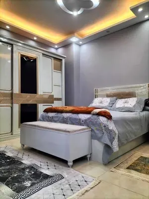 a bedroom with a large bed and a ceiling at رحيق الزخور هاوس in Madaba