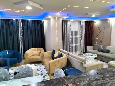 a living room with couches and blue lighting at رحيق الزخور هاوس in Madaba