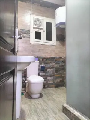 a bathroom with a toilet and a sink at رحيق الزخور هاوس in Madaba