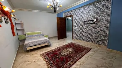 a bedroom with a bed and a stone wall at رحيق الزخور هاوس in Madaba