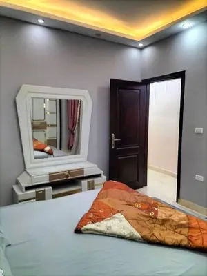 a bedroom with a bed and a mirror at رحيق الزخور هاوس in Madaba