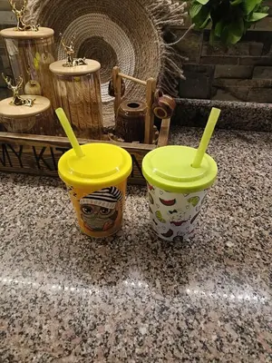 two yellow cups sitting on top of a counter at الاغوار bb in Khirbat ash Shaykh Muḩammad
