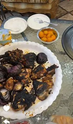a plate of food on a table with some food at ريمون هاوس in Kafr Khall