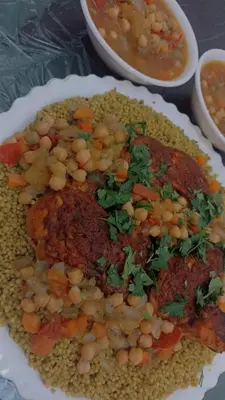 a plate of food with beans and a bowl of soup at ريمون هاوس in Kafr Khall