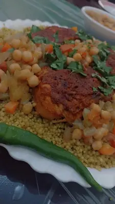 a plate of food with rice and meat and vegetables at ريمون هاوس in Kafr Khall