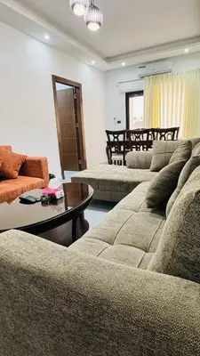 a living room with two couches and a table at شقق فاخره للايجار in Amman